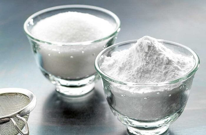 White homemade powdered sugar dusted over a dark surface
