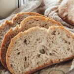 Rustic homemade sourdough loaf with a golden scored crust