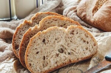 Rustic homemade sourdough loaf with a golden scored crust