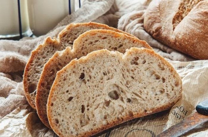 Rustic homemade sourdough loaf with a golden scored crust