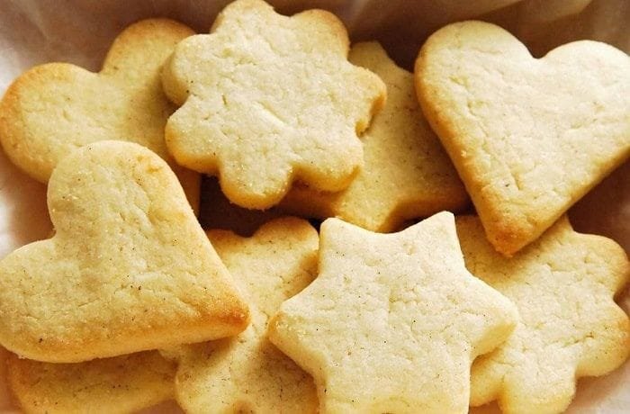 Freshly baked homemade vanilla cookies cut into shapes