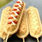 Homemade yoguis or waffle dogs on sticks served with ketchup and mustard