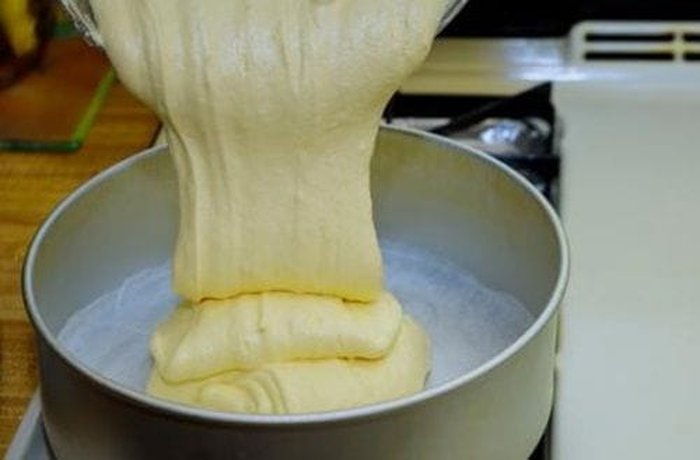 Lemon cake batter poured into a greased tin