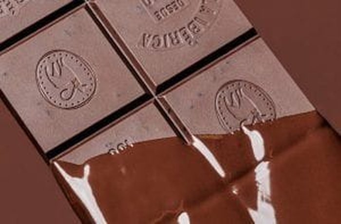 Cocoa-concentrated chocolate melting gently in a double boiler for the final coating.