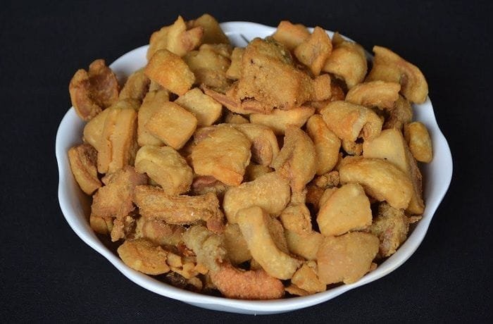 Chopped pork chicharrones to top the potato broth