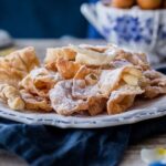 Punta Arenas cintas fritas, Croatian krostule pastry ribbons dusted with powdered sugar