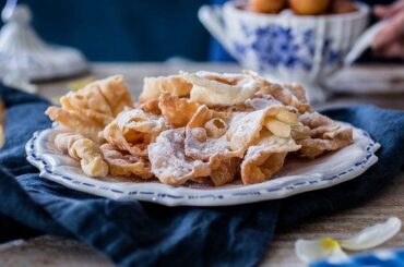 Punta Arenas cintas fritas, Croatian krostule pastry ribbons dusted with powdered sugar