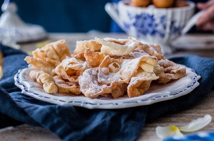 Punta Arenas cintas fritas, Croatian krostule pastry ribbons dusted with powdered sugar