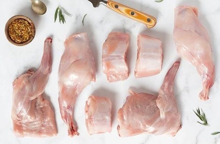 Rabbit pieces in a pot, ready for the sofrito