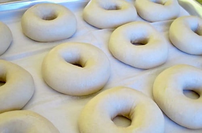 Raw dough rings with their characteristic donut shape, ready to fry.