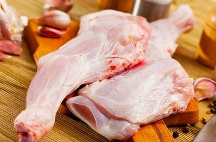 Bone-in pieces of goat meat marinating with spices.