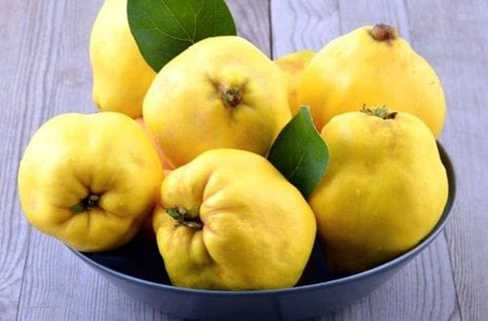 Ripe yellow quinces, whole and cut into wedges