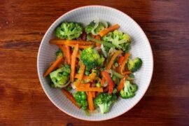 Colorful sautéed vegetables with broccoli, peppers, carrots, and peas