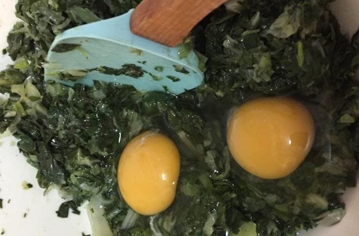 Budin mixture of chopped chard, eggs, and beef sofrito in a bowl