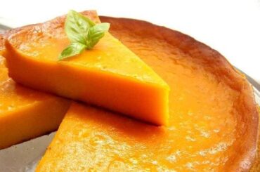 Freshly baked Venezuelan torta de auyama with a golden top, cut into portions
