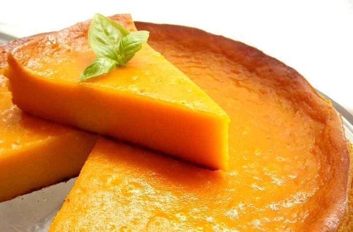 Freshly baked Venezuelan torta de auyama with a golden top, cut into portions