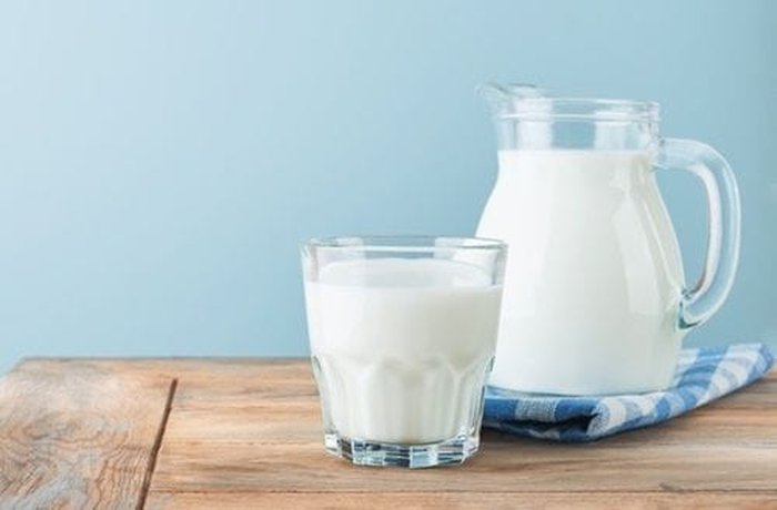 Whole milk being poured to build the cheese sauce base.