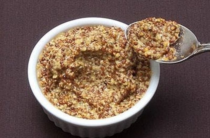 Wholegrain mustard in a small white bowl, ready to be mixed into the roast beef marinade