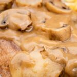 Sliced beef tongue in a creamy mushroom sauce