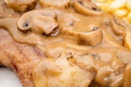 Sliced beef tongue in a creamy mushroom sauce