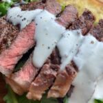 Creamy blue cheese sauce over grilled beef