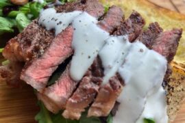 Creamy blue cheese sauce over grilled beef