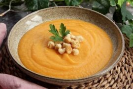 Carrot cream soup with croutons and parsley