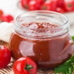 Homemade cherry tomato jam in a glass jar