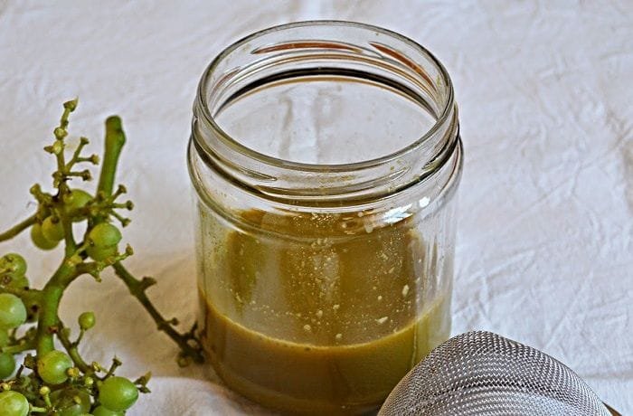 Chilean agraz, the sour juice of unripe green grapes, in a glass bottle