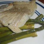 Chilean baked fish with potatoes and vegetables in a baking dish