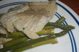Chilean baked fish with potatoes and vegetables in a baking dish