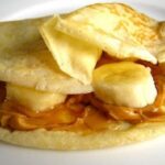 Chilean panqueques filled with caramelized banana and manjar, dusted with powdered sugar