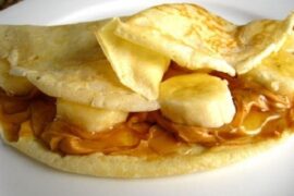 Chilean panqueques filled with caramelized banana and manjar, dusted with powdered sugar