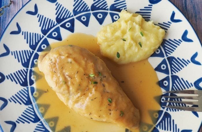 Chilean braised chicken, pollo al jugo, with onion and bay leaf in its juices