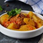 Chilean chicken stew with potatoes and carrots in tomato sauce