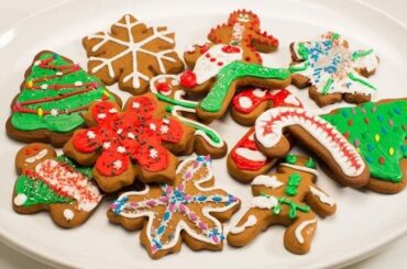Chilean Christmas cookies cut into festive shapes and decorated with colored icing and sprinkles