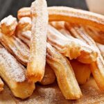 Homemade Chilean churros, crisp and golden, some dipped in chocolate
