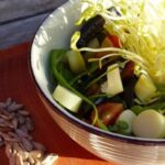 Chilean coligüe bamboo shoot salad with cherry tomatoes, olives, and spinach