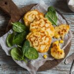 Golden Chilean corn fritters, croquetas de choclo, on a plate