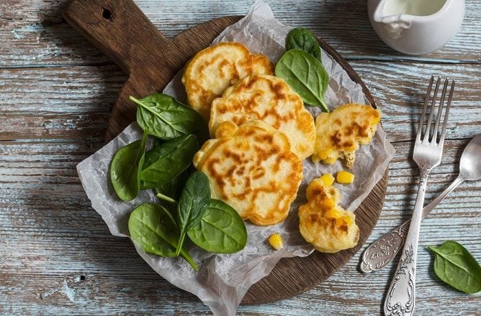 Golden Chilean corn fritters, croquetas de choclo, on a plate