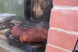 Chilean grilled beef brisket sliced with a dark crust, tapapecho a la parrilla cooked over indirect heat