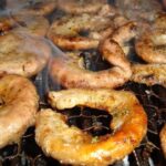 Golden, crispy Chilean grilled chunchules, a classic of the Chilean barbecue