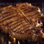 Chilean grilled entrecôte steak with grill marks, resting on a board