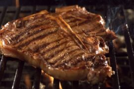 Chilean grilled entrecôte steak with grill marks, resting on a board