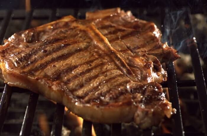 Chilean grilled entrecôte steak with grill marks, resting on a board