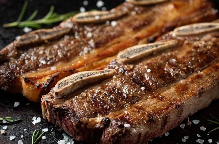 Chilean grilled beef short ribs, asado de tira a la parrilla, cut between the bones