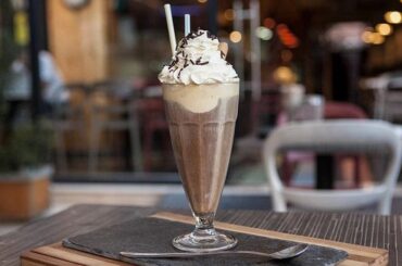 Chilean café helado, iced coffee with vanilla ice cream, whipped cream, and wafer rolls