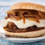 Chilean lamb sandwich with melted sheep cheese and sautéed onion in pan amasado