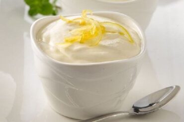 Chilean lemon foam served in individual dessert cups with lemon zest and fresh mint