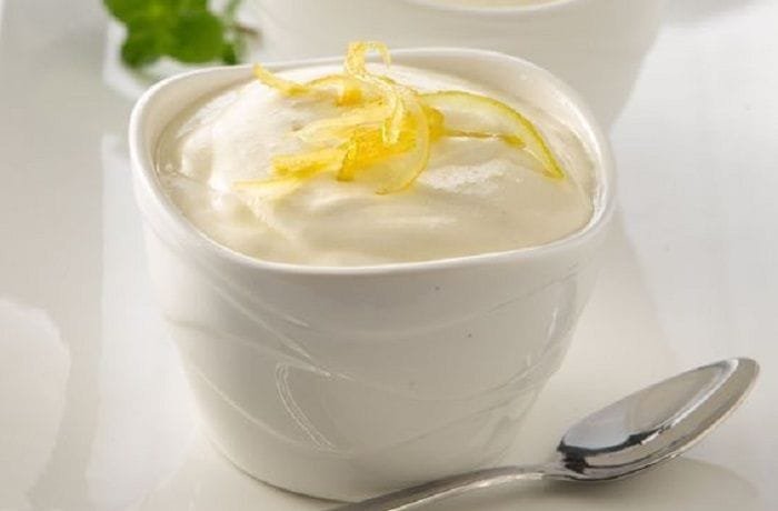 Chilean lemon foam served in individual dessert cups with lemon zest and fresh mint